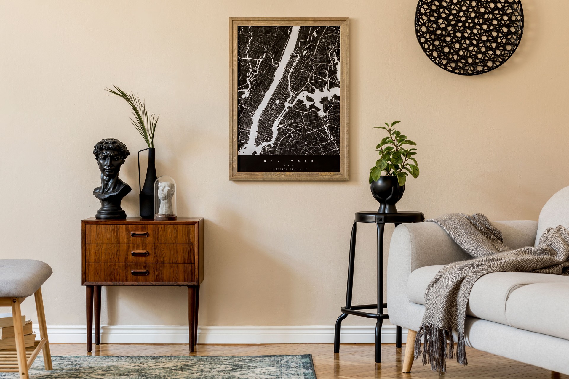 Design scandinavian home interior of living room with mock up poster map, stylish wooden commode, bench, sofa, flowers in vase and elegant personal accessories. Modern home staging. Template. Japandi.