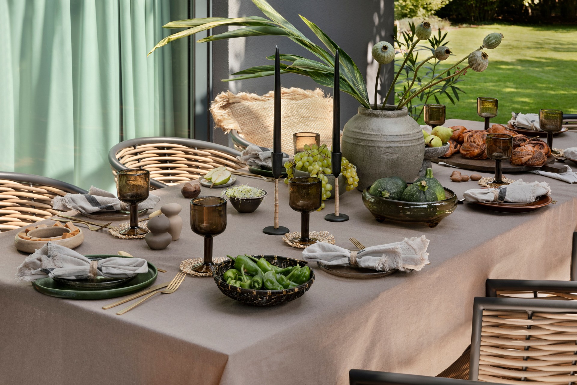 Interior design of  terrace with table, garden chair, vase with flowers, bowl with fruits, tableware, beautiful garden and personal accessories. Home decor. Template.